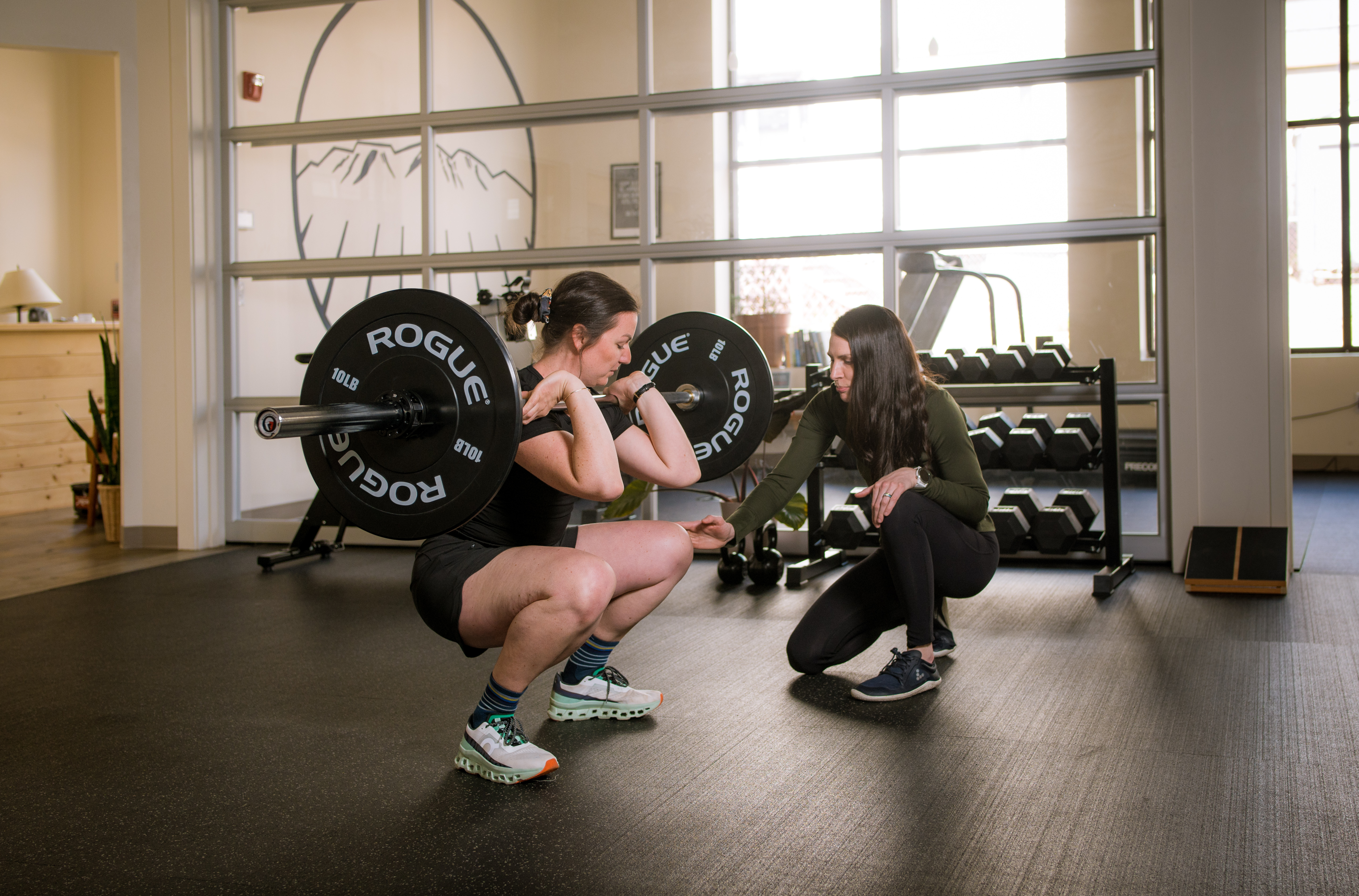 Clinician coaching a client lifting